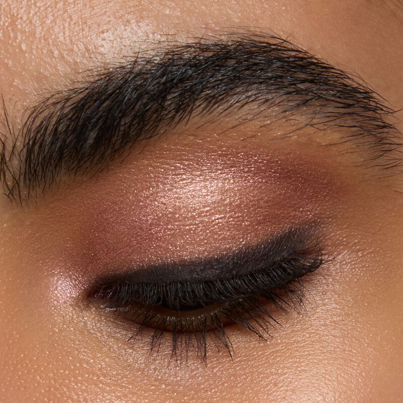 Medium skinned model wearing Mary kay Eye Shadow Sticks in shades Copper Nova and Black Obsidian